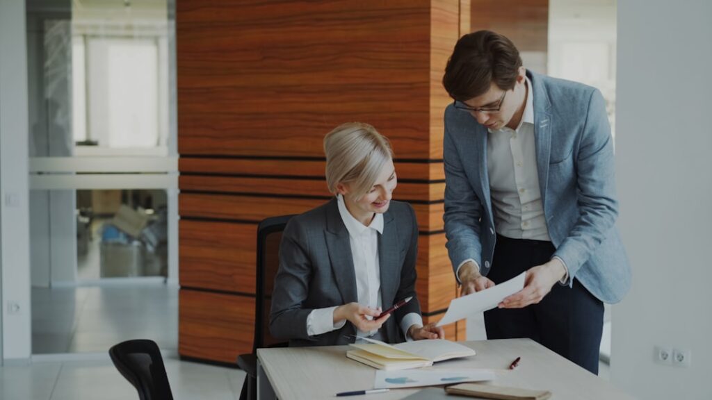 Funding advisor reviewing revenue-based financing paperwork with a business owner